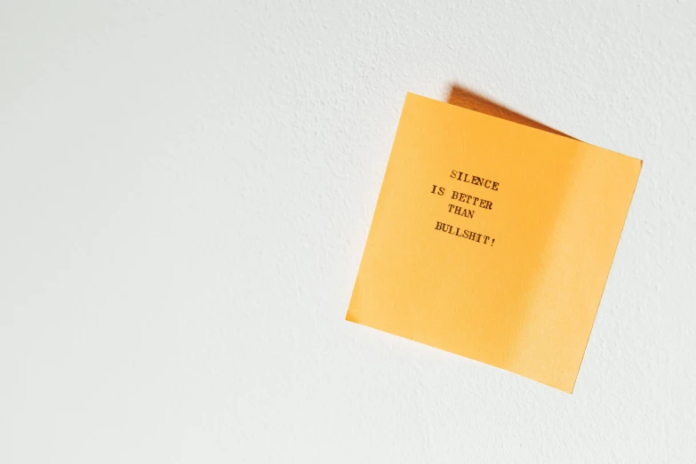 a piece of paper sitting on top of a refrigerator, unsplash, postminimalism, yellow-orange, message, ignant, violence