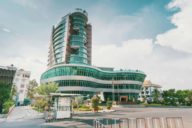 a building with green and white curved glass walls