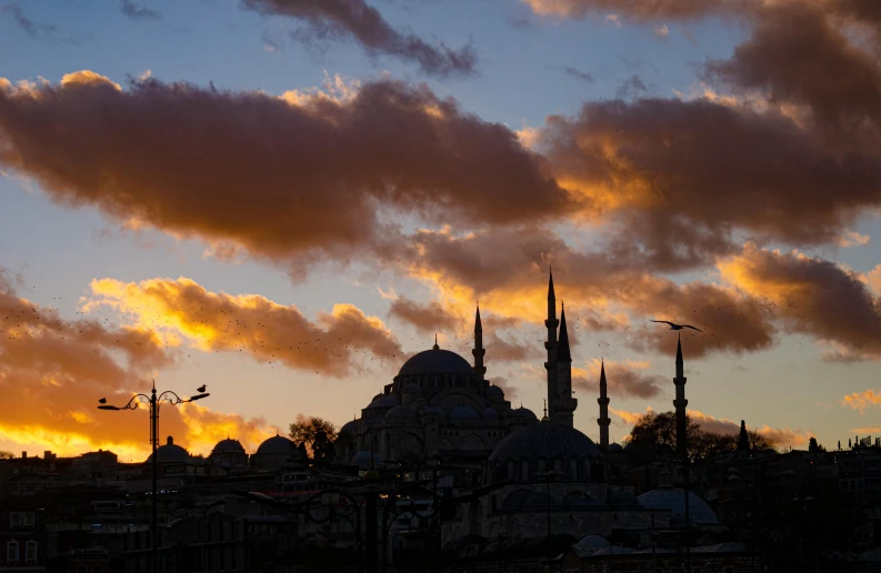 a sky filled with lots of clouds next to a tall building, by Ismail Acar, pexels contest winner, hurufiyya, with great domes and arches, mixture turkish and russian, godrays at sunset, slide show
