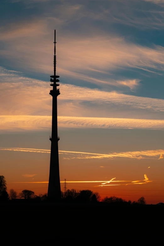 a tall tower sitting in the middle of a field, by Paweł Kluza, city sunset, radio signals, tallinn, arc