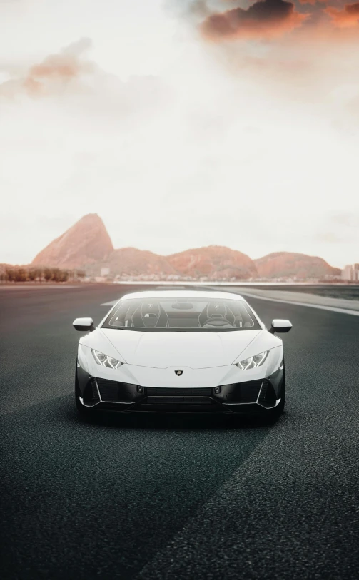 a white car sits alone on an asphalt road