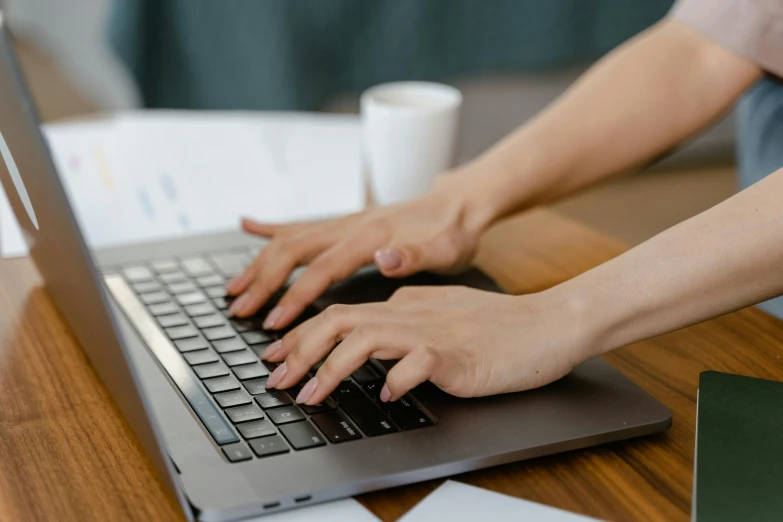 a close up of a person typing on a laptop, by Carey Morris, trending on pexels, avatar image, background image, sitting on a mocha-colored table, no - text no - logo