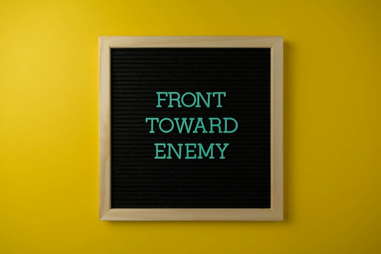 a letter board with the words front toward enemy on it, pexels contest winner, sots art, forward facing, squad, wide frontal view, front angle