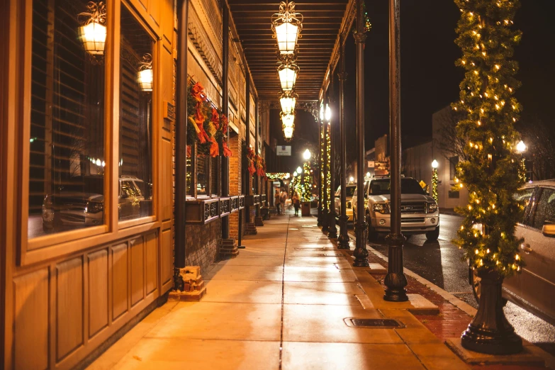 the lights are on and trees are decorated by the lamps