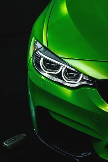 a close up of the front grille of a green sports car