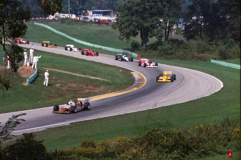 a group of cars driving down a race track, from 1986, rob and hildebrandt, carrington, center of picture