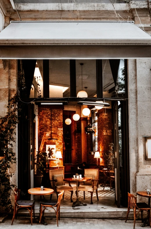 a restaurant with tables and chairs outside of it, by Niko Henrichon, pexels contest winner, art nouveau, light coming from the entrance, hygge, concept eclectic, brown