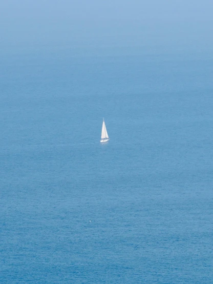 a sailboat in the middle of a large body of water, by Nassos Daphnis, minimalism, cinq terre, zoomed in, medium-shot, 2 5 6 x 2 5 6 pixels