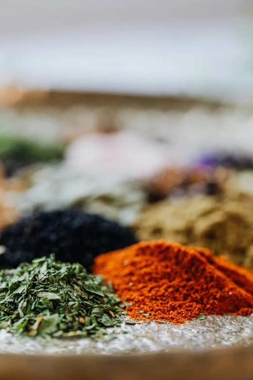 a bowl filled with lots of different types of spices, by Julia Pishtar, trending on unsplash, renaissance, closeup shot of face, high quality photo, iceland, textiles