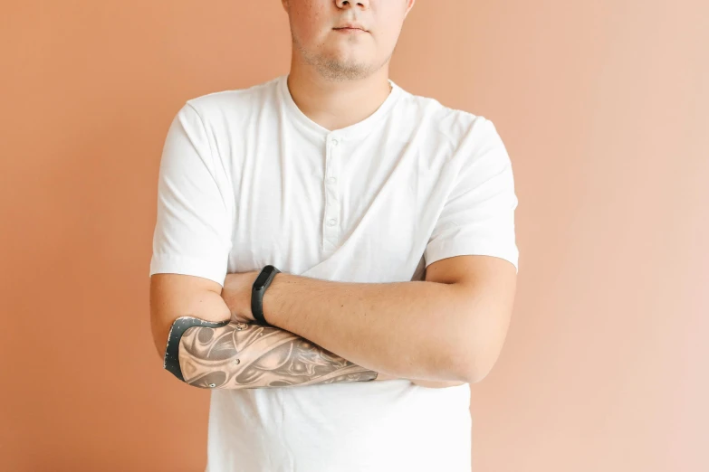 a man with a tattoo on his arm, trending on pexels, wearing a light shirt, slightly overweight, ken wong, aged 2 5