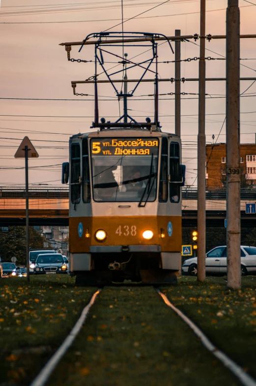 the front of a trolley on tracks at dusk