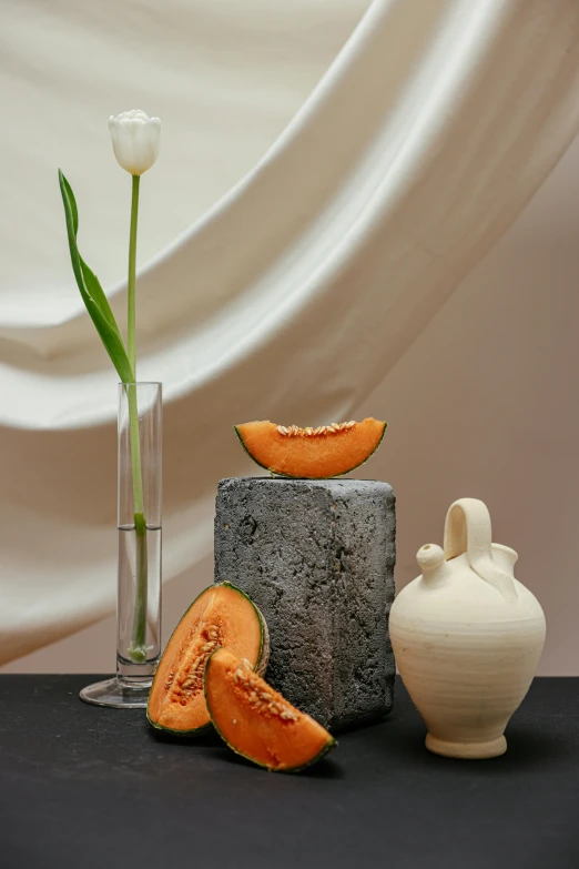 a couple of vases sitting on top of a table, a still life, shutterstock contest winner, grey orange, snacks, mango, stone sculpture