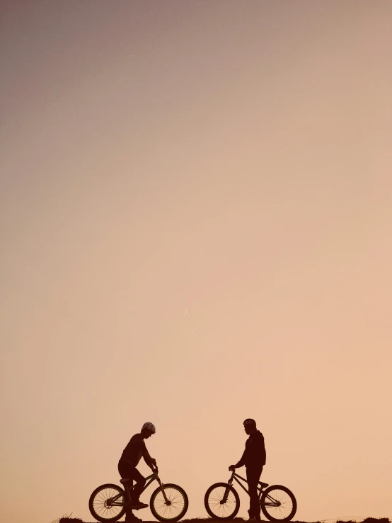 a couple of people riding bikes on top of a hill, by Peter Churcher, unsplash, minimalism, praying, ilustration, reza afshar, low sunset