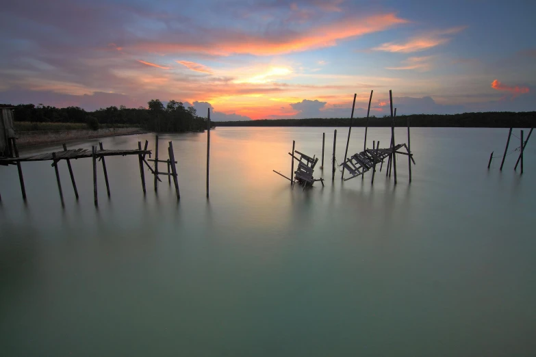 a boat sitting on top of a body of water, by Basuki Abdullah, unsplash contest winner, romanticism, ruins around, pastel sunset, docks, album cover