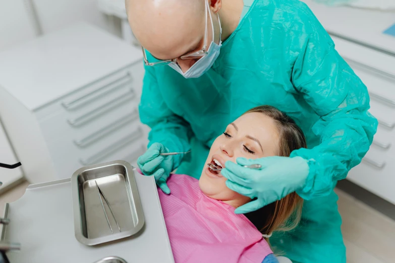 a woman getting her teeth brushed by a dentist, by Adam Marczyński, pexels contest winner, hurufiyya, thumbnail, biting lip, acid leaking from mouth, profile image