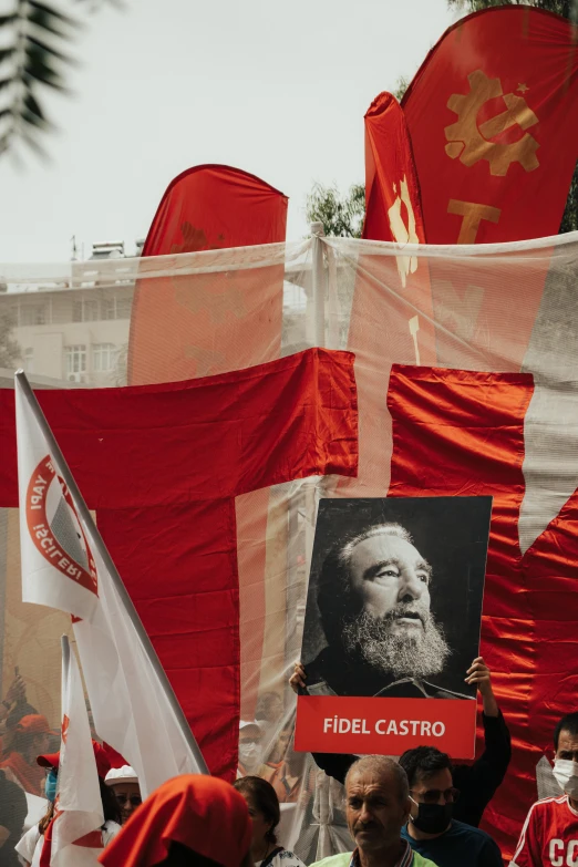 protestors carry a pograph of che guen luong