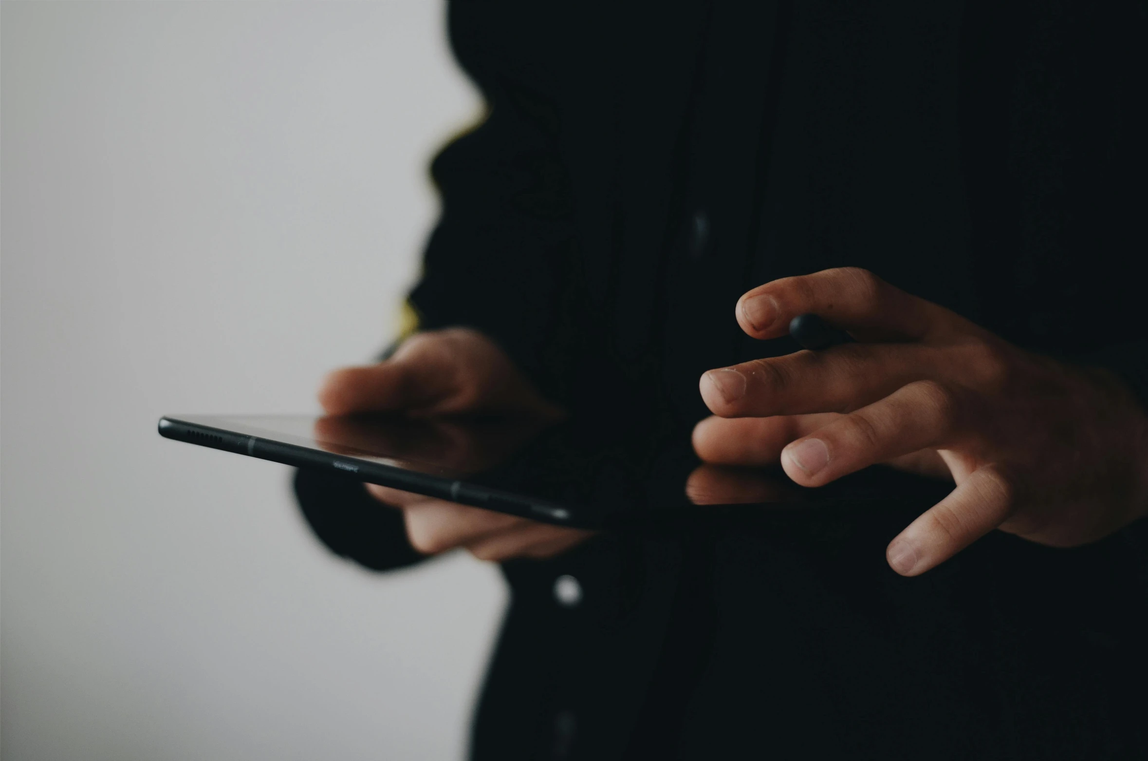 a man holding an electronic device in his hand