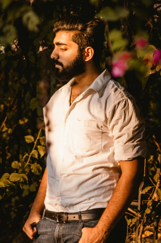 a man is standing in front of flowers