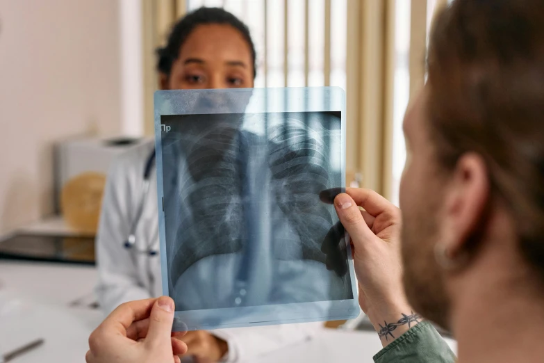 a doctor looking at an x - ray of a patient, pexels contest winner, hurufiyya, chest high, instagram post, fall season, thumbnail