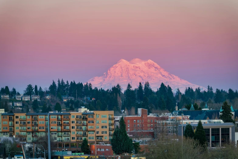 there is a mountain behind a building that stands in the distance