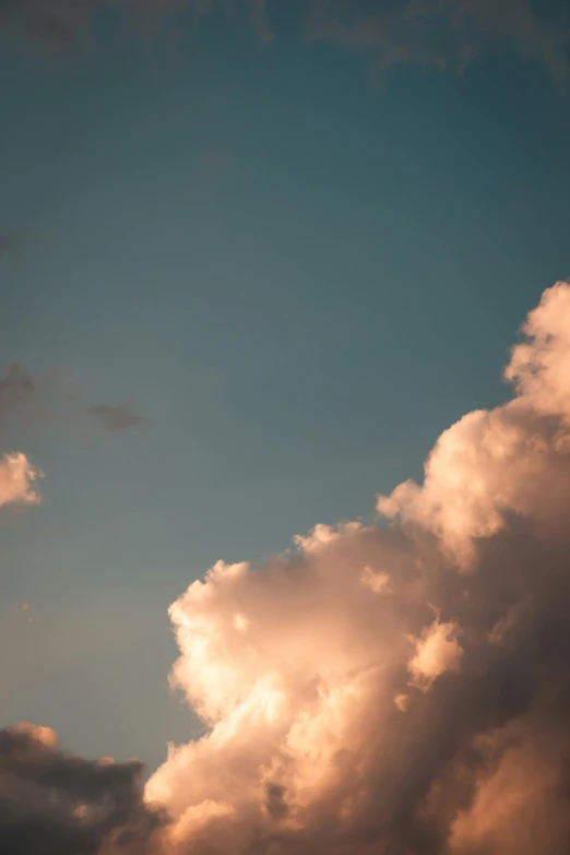 a plane flying through a cloudy blue sky, by Daniel Seghers, late summer evening, paul barson, up-close, cotton candy clouds