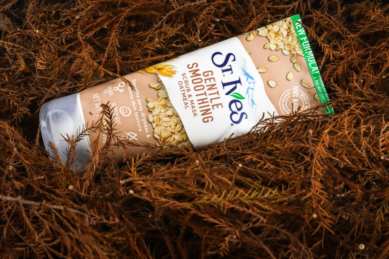 a tube of oatmeal sitting on the ground, with seaweed, detailed product image, sweltering, stubble