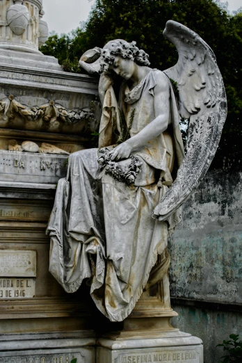 a statue of an angel sitting on top of a grave, parce sepulto, hauntingly beautiful, over the shoulder, nice