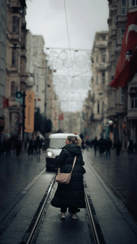 a woman walking down a street on a rainy day, by Niyazi Selimoglu, pexels contest winner, hyperrealism, turkey, lightroom preset, with vray, square