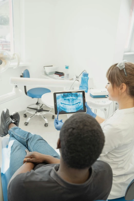 a couple of people that are sitting in a chair, large teeth, digital medical equipment, mkbhd, pastel'