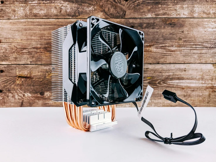 a cooler sitting on top of a wooden table, a computer rendering, by Tom Wänerstrand, unsplash, graphics card, black and gold wires, фото девушка курит, instagram picture