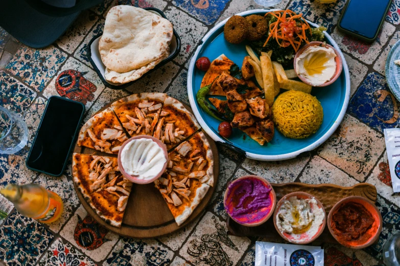 a table topped with plates of food and drinks, les nabis, middle eastern skin, thumbnail, pizza the hut, 🦩🪐🐞👩🏻🦳