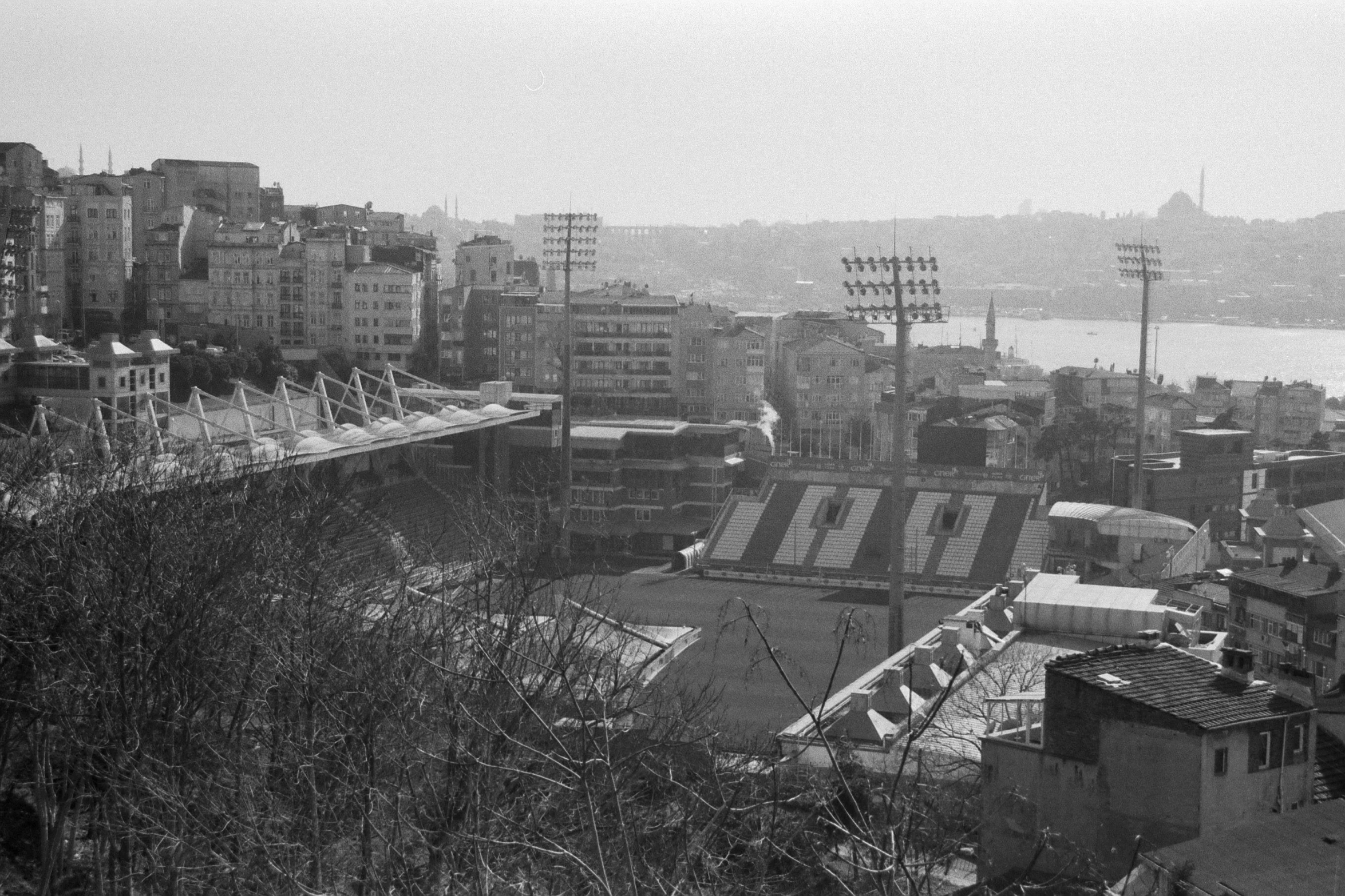 black and white image of city with large clock tower