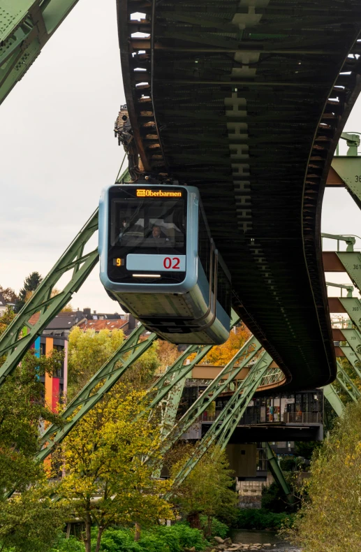 a train is going under a tall bridge