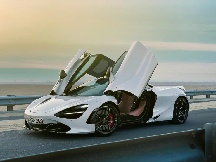 a white and black sports car with open doors