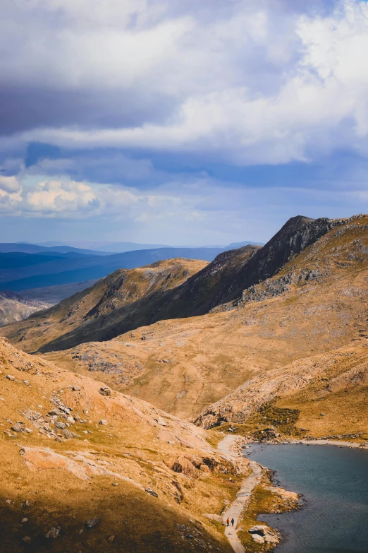 a view of some hills and the lake