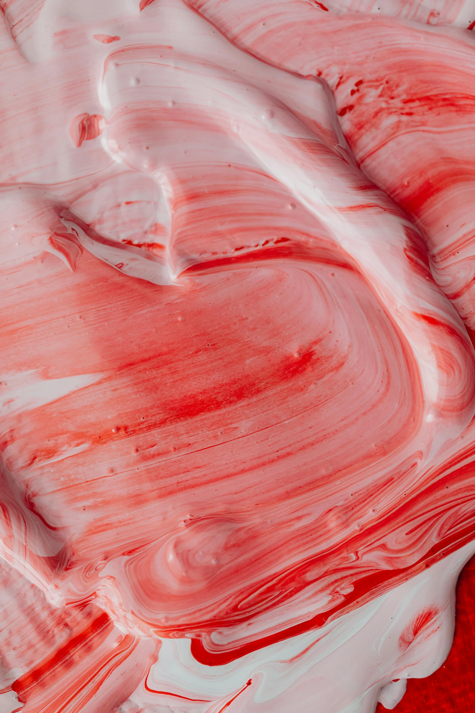 a close up of red and white paint on a red surface, inspired by Anish Kapoor, trending on pexels, made of candy, marbled swirls, strawberry ice cream, made of glazed