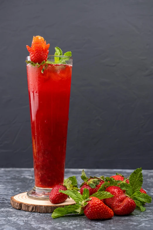 a drink sitting on top of a table next to a pile of strawberries, on a gray background, mint, no cropping, hurricane