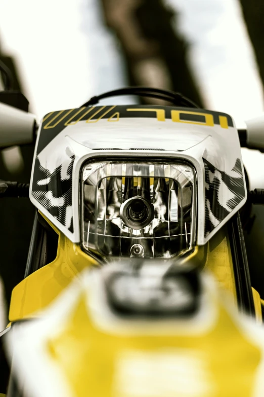 the front light of a yellow motorcycle