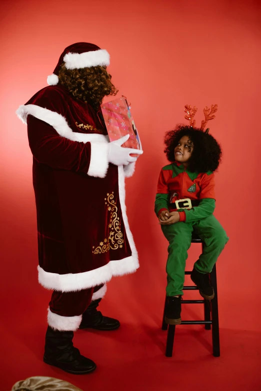 a  in santa costume poses next to a man wearing an outfit with the santa clause on it