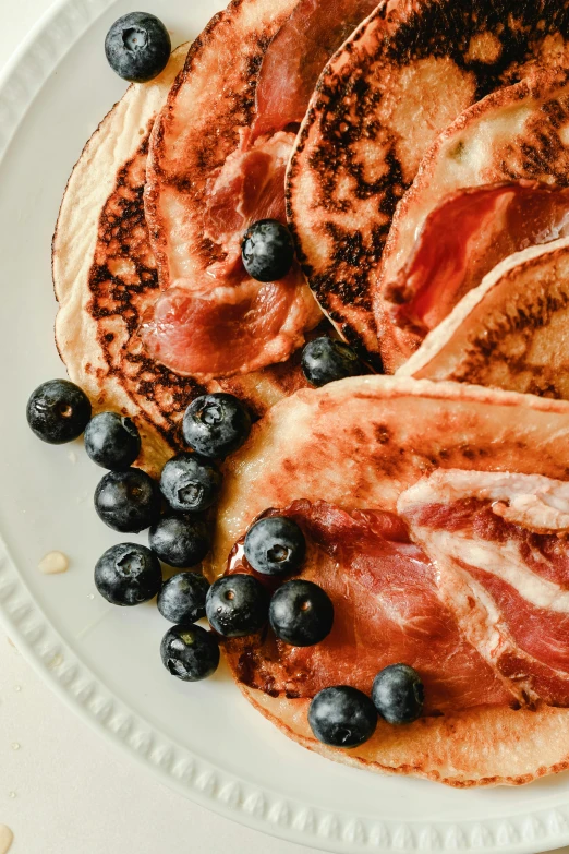 a bunch of pancakes that are on a white plate