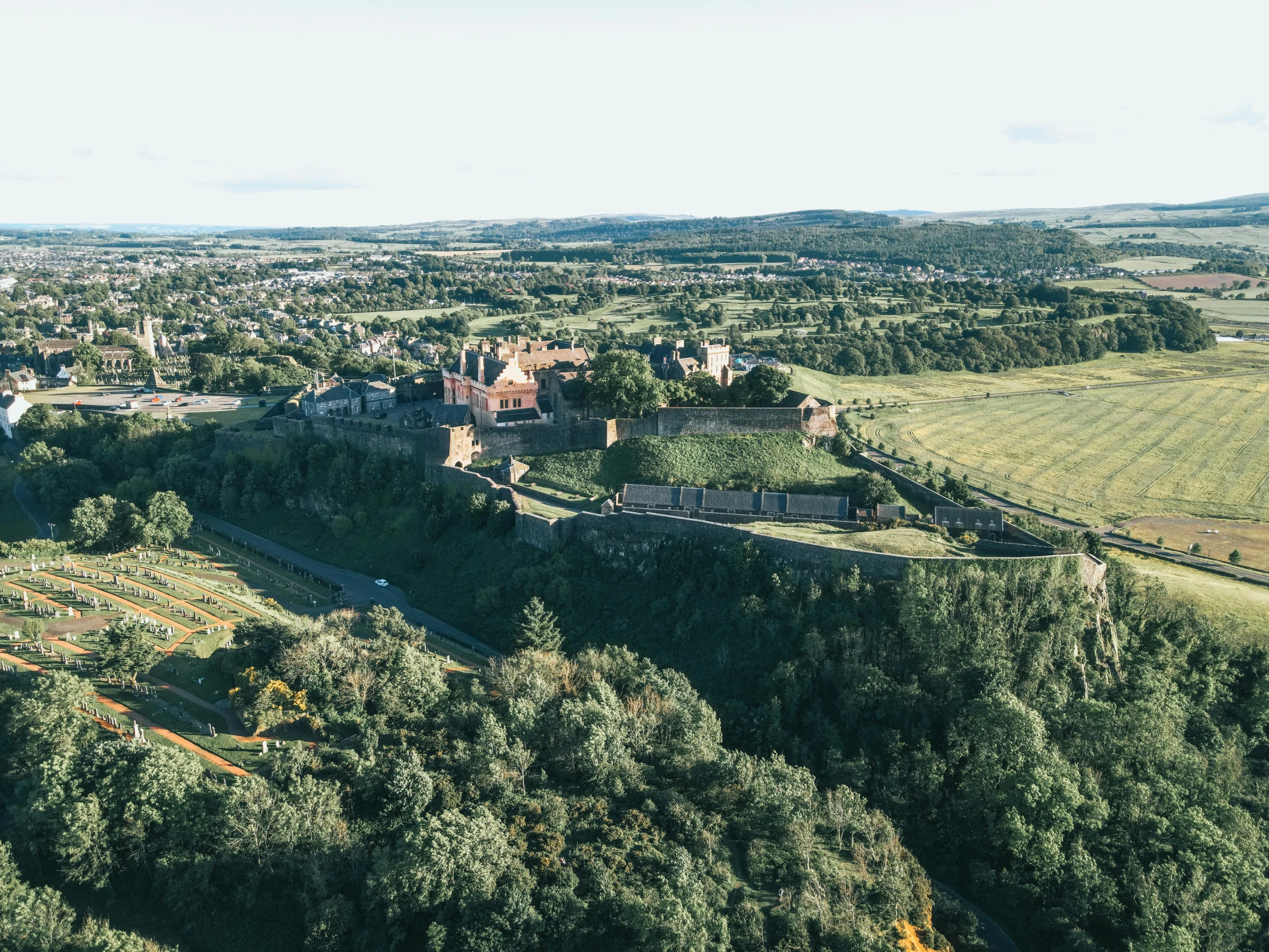 an aerial po of a large building on a hill