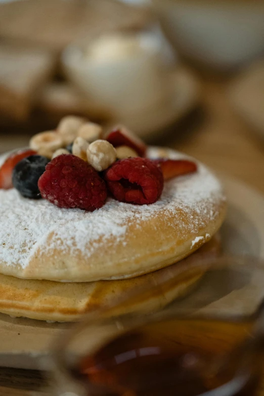 the fruit is on top of pancakes with sugar and nuts