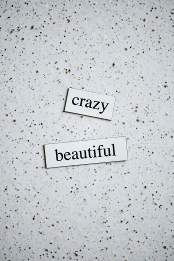 two pieces of paper that say crazy and beautiful, unsplash, magnetic, beautiful girlfriend, labels, bright white porcelain