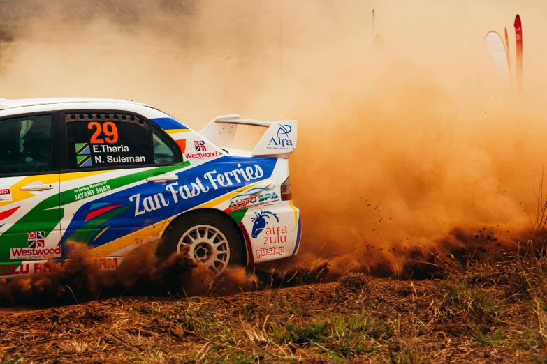 a very pretty and colorful car driving in the dirt