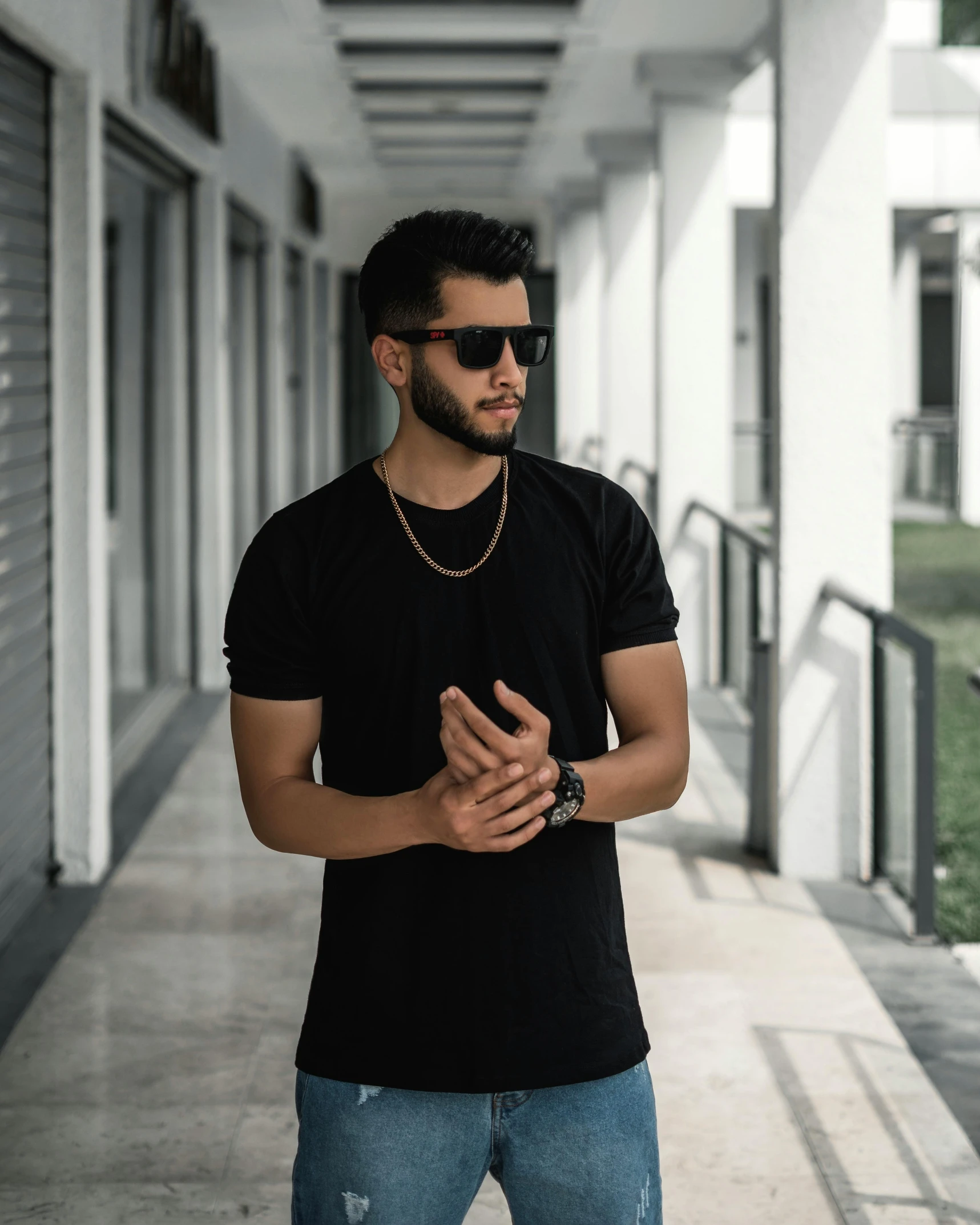 a man wearing a black shirt and blue jeans, by Ismail Acar, pexels contest winner, wearing a gold chain, wearing a black!! t - shirt, dark shades of colors, young male