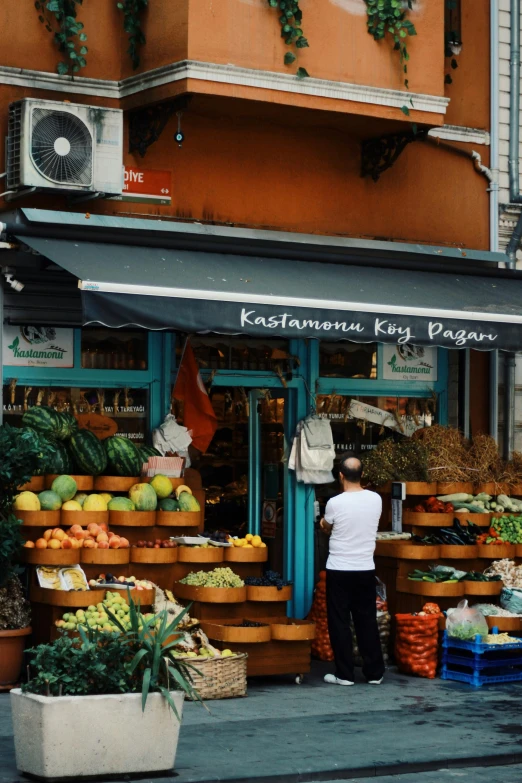 a person is looking at different foods at an outdoor market