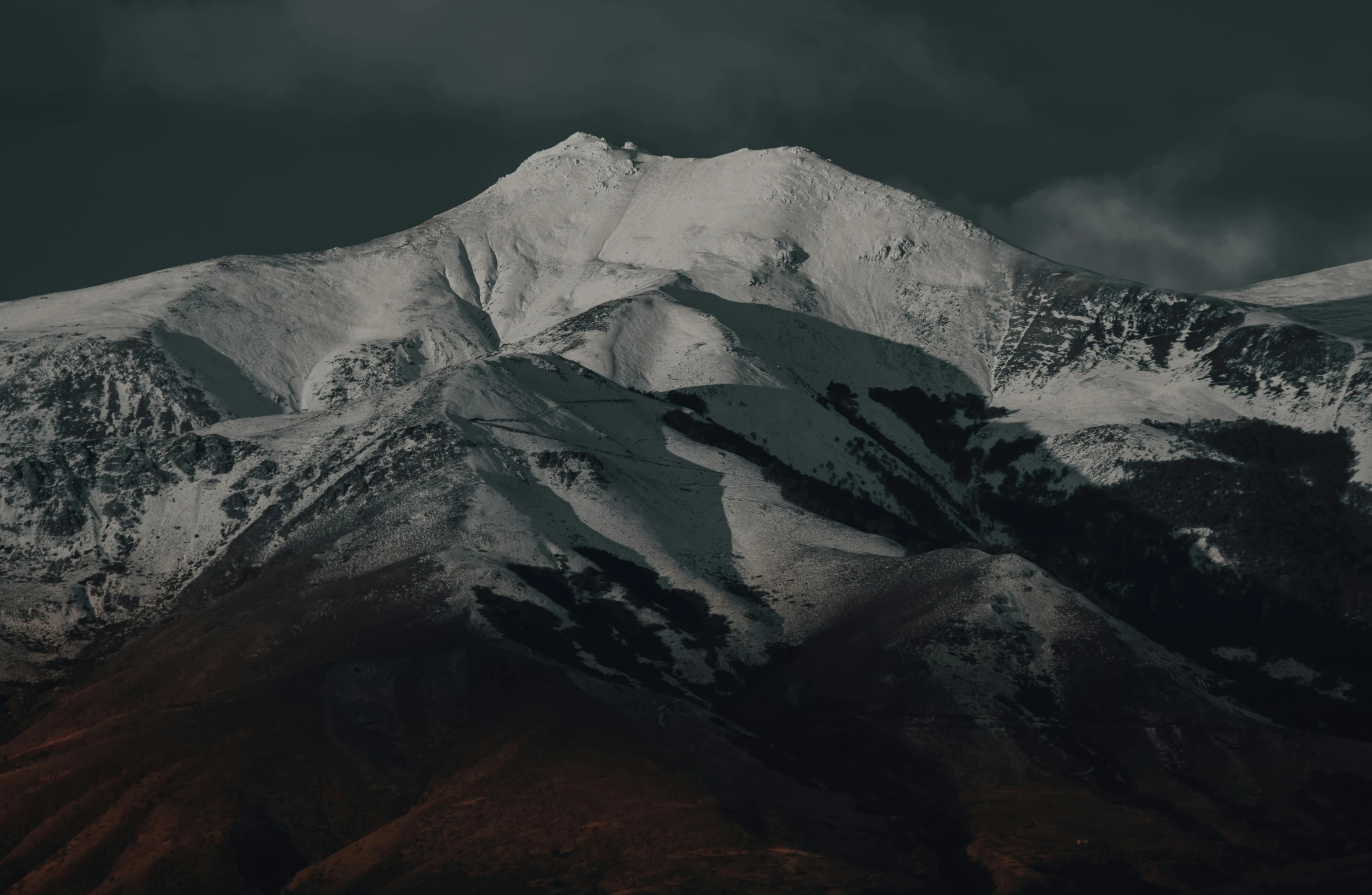 a large white mountain is covered in snow