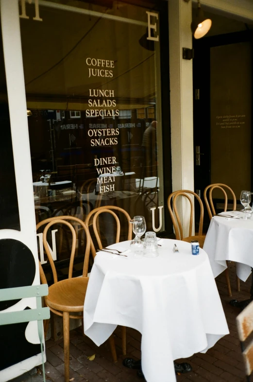 a restaurant patio that has some tables set for two