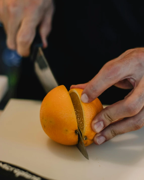 a person cutting an orange with a knife, profile image, rex orange county, multiple stories, gourmet and crafts
