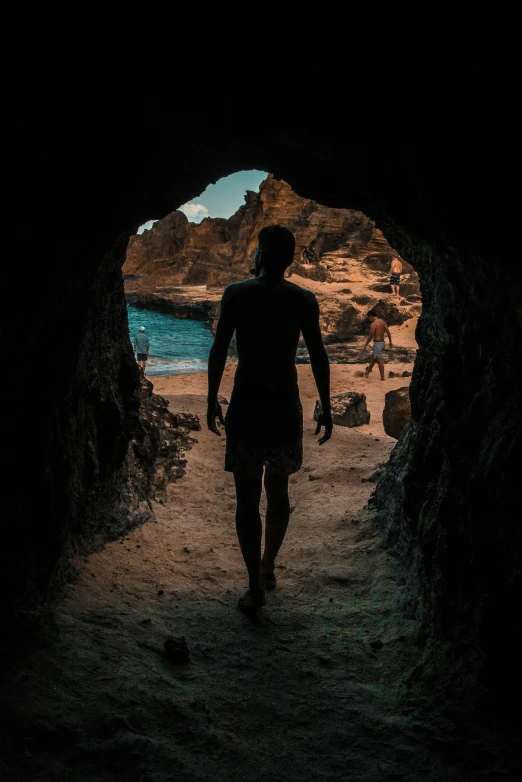 a man walking out of a cave into the ocean, by Matt Stewart, pexels contest winner, renaissance, hawaii beach, walking out of a the havens gate, stylized silhouette, slightly tanned